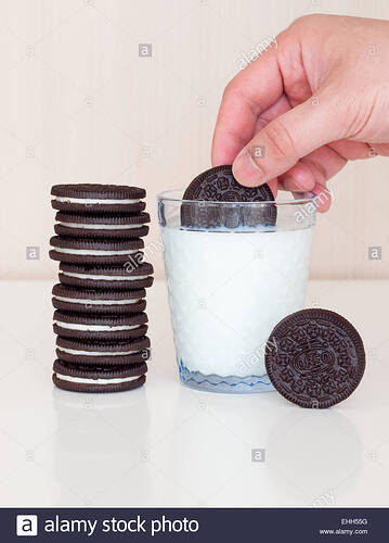 dunking-an-oreo-cookie-in-a-glass-of-milk-EHH55G