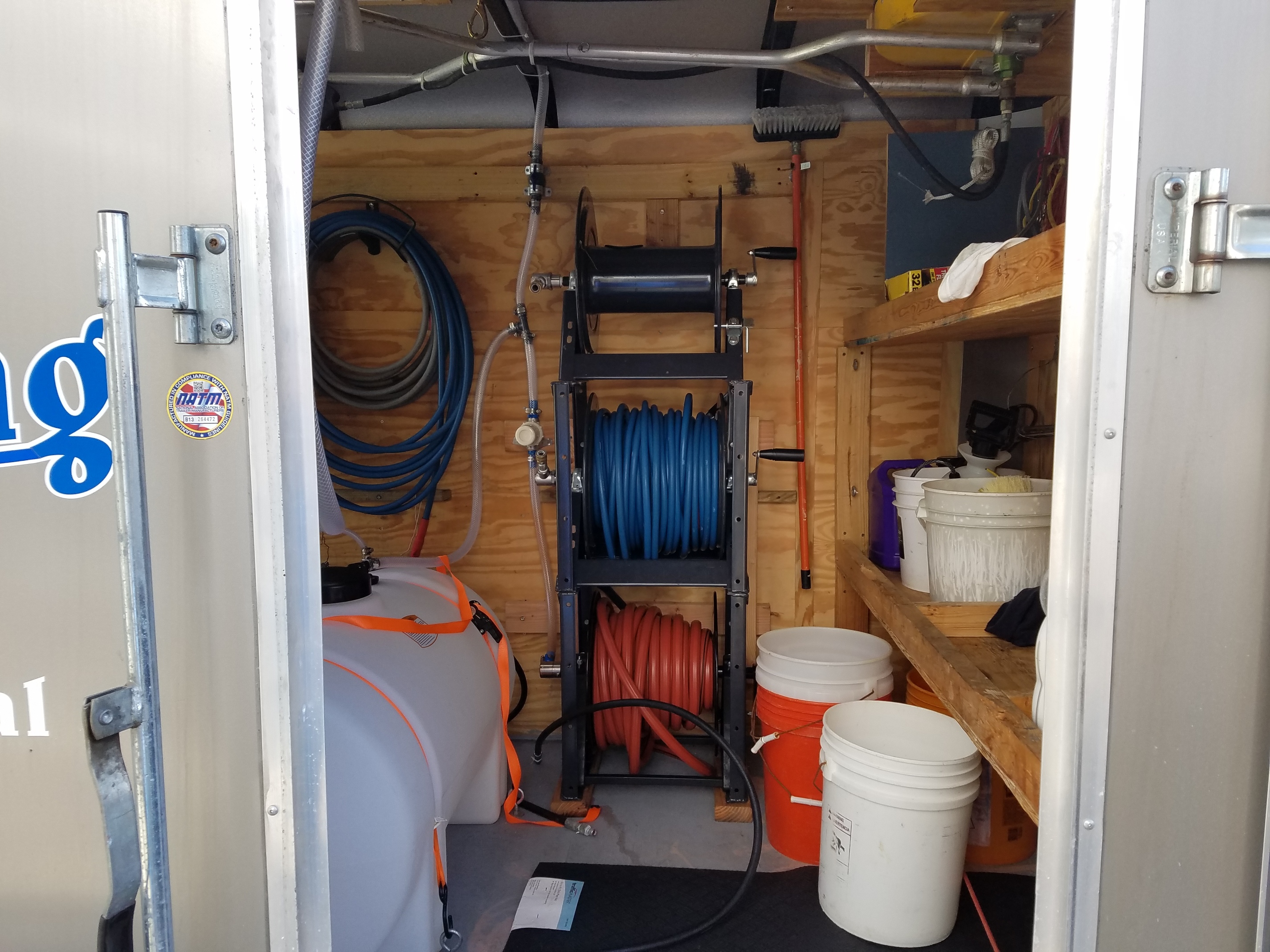 Stacked reels in enclosed trailed Trailer Builds Pressure Washing